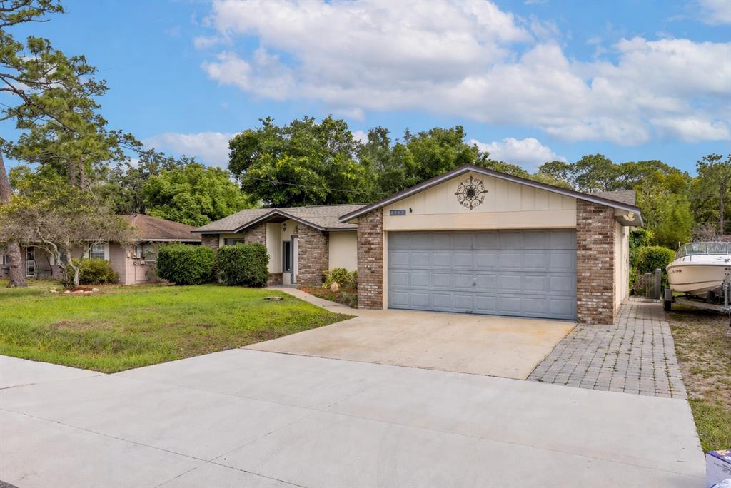 A single-story brick and stucco house with a two-car garage and a front lawn — 2707 BALKAN STREET, APOPKA, FL