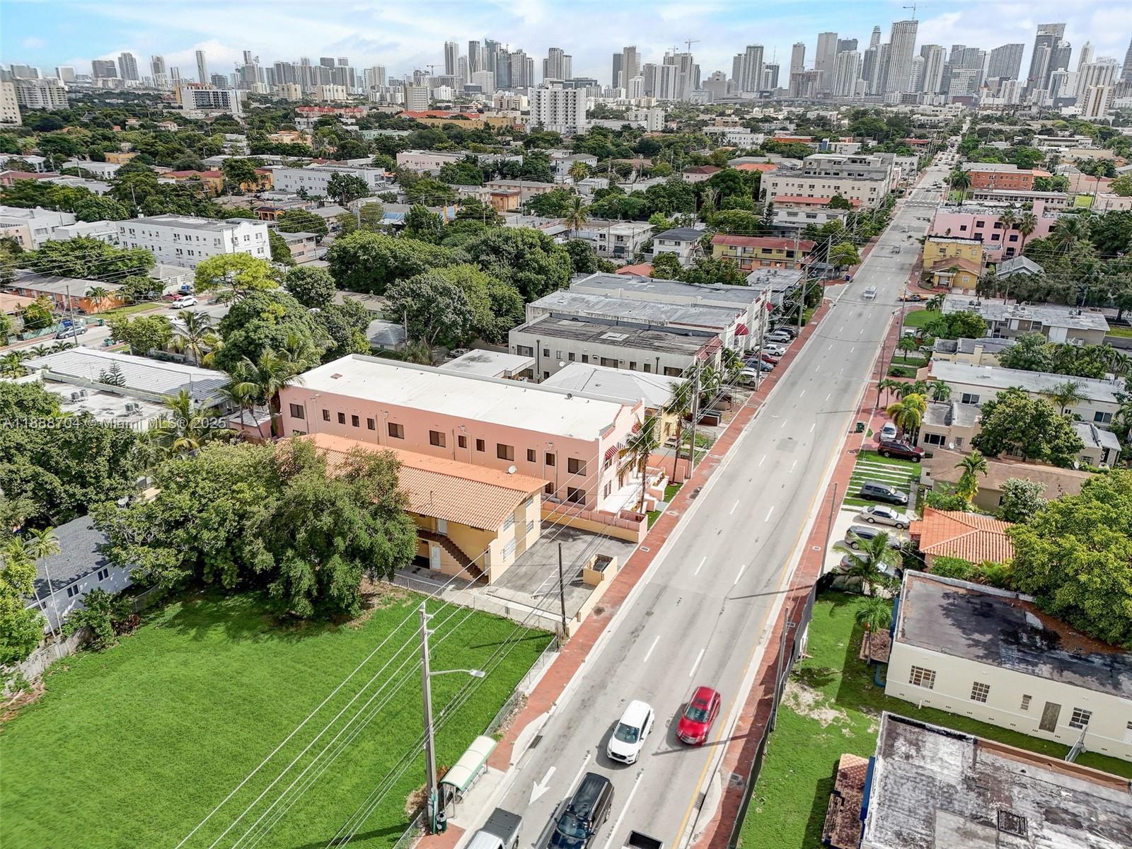 An aerial view shows a multi-story pink building next to a road with traffic — 1553 SW 7th St, Miami FL 33135, MIAMI, FL