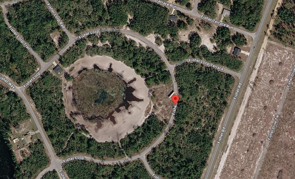 This is an aerial map view of a circular road surrounding a central pond — 62 FISHER LOOP, OCKLAWAHA, FL