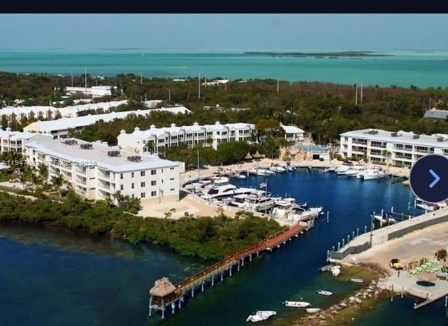An aerial view of a waterfront condominium complex with a private marina and long pier — 97501 Overseas Hwy # 906, Key Largo FL 33037, KEY LARGO, FL