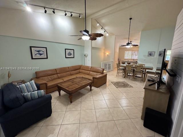 A living room with a tan sectional sofa, a dark armchair, and tile flooring — 97501 Overseas Hwy # 906, Key Largo FL 33037, KEY LARGO, FL
