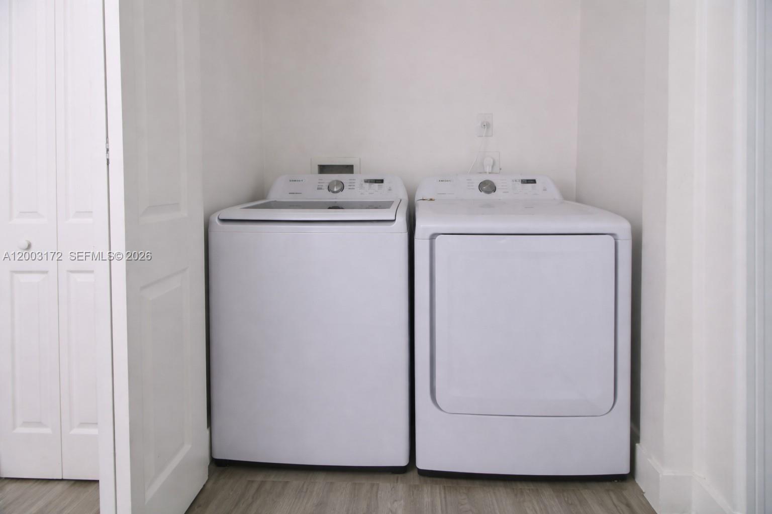 A white top-load washing machine and dryer are placed in a laundry closet — 2264 NE 42nd Cir, Homestead FL 33033, HOMESTEAD, FL
