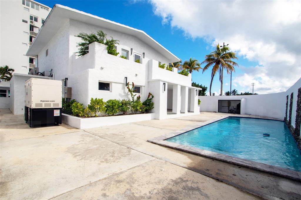 A white two-story house with a swimming pool and a large generator in the yard — 2073 CACIQUE STREET, SAN JUAN, PR