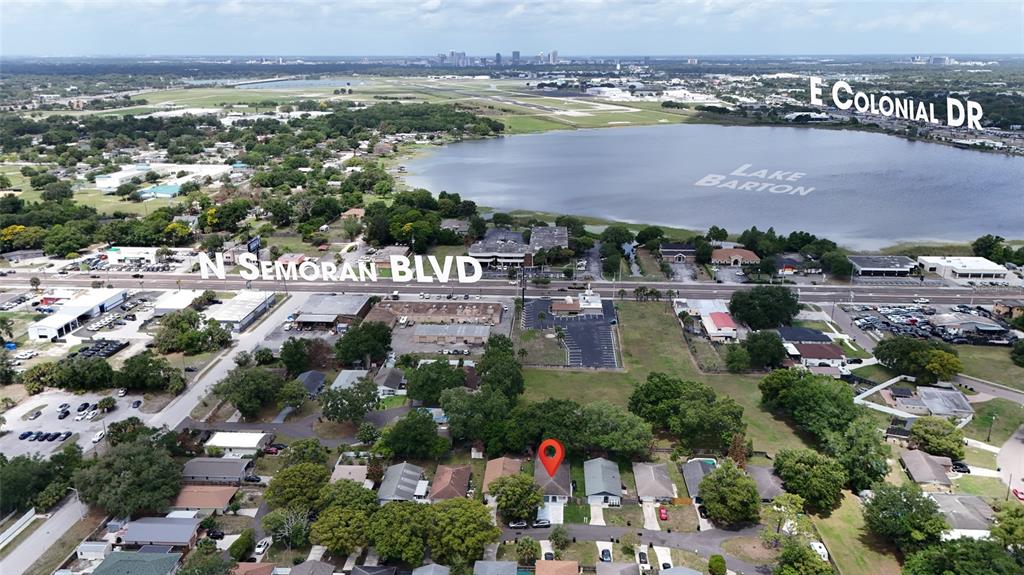 This aerial view shows a residential neighborhood with a red location pin on a house — 536 HIBISCUS WAY UNIT 7B, ORLANDO, FL