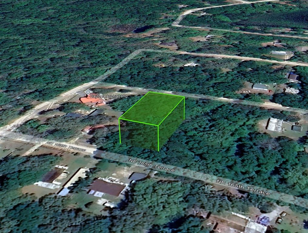 An aerial view shows a rectangular plot of land highlighted in green near a road — NE 165TH TERRACE, SILVER SPRINGS, FL
