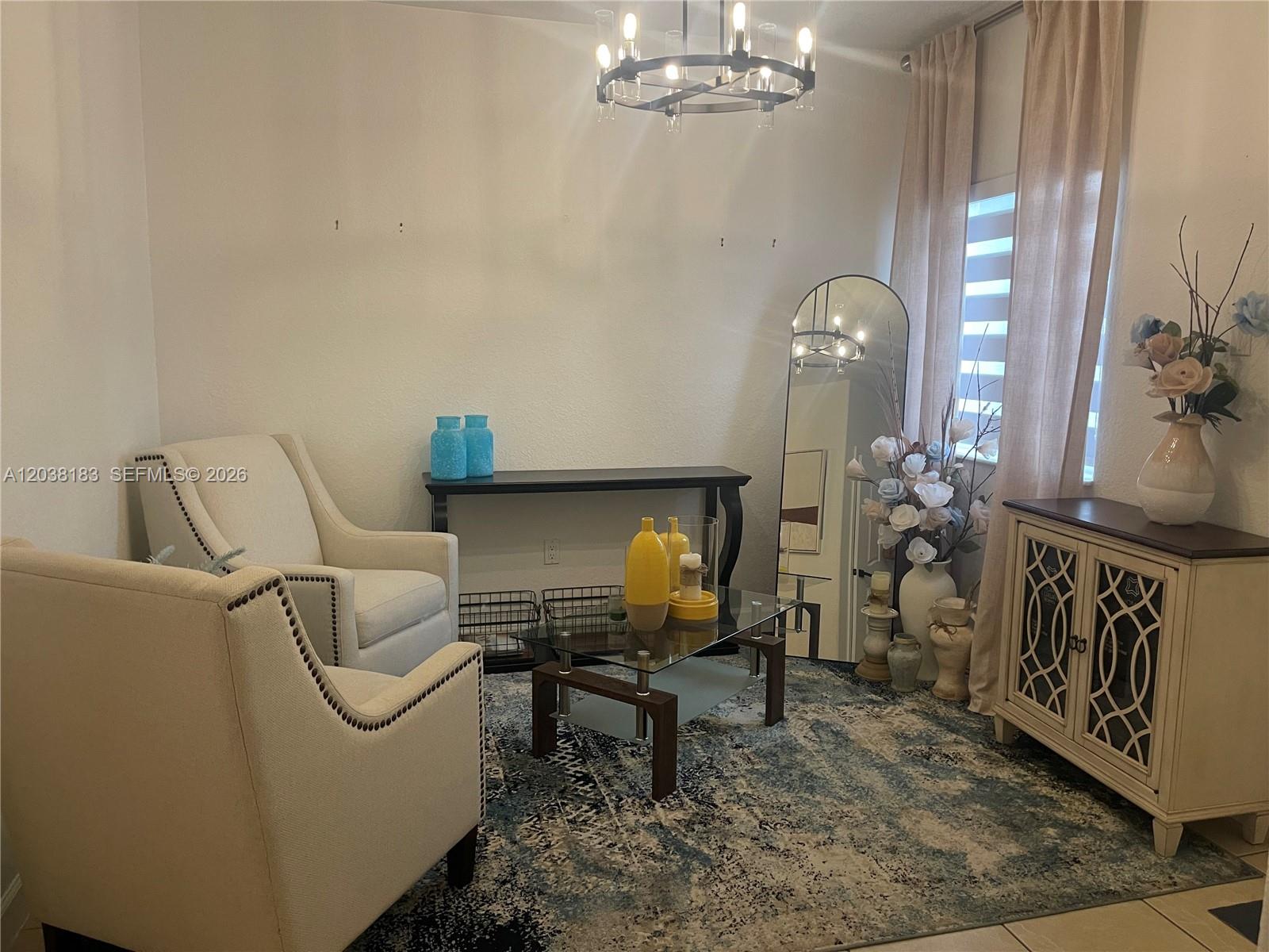 A living area features two armchairs, a glass coffee table, a console table, and a mirror — 16364 SW 44th Way, Miami FL 33185, MIAMI, FL