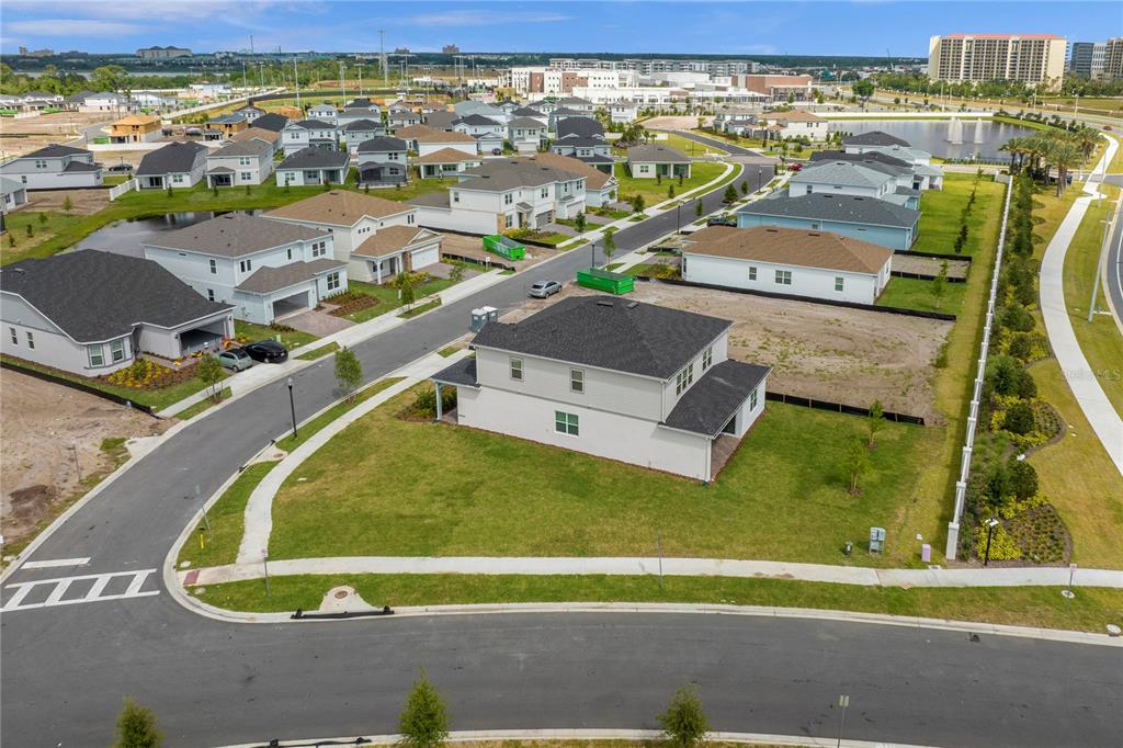 An aerial view shows a two-story suburban house on a corner lot with surrounding homes — 10411 PARK ESTATES AVENUE, ORLANDO, FL