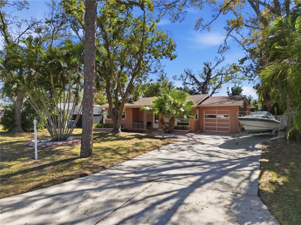 An aerial view shows a residential neighborhood near a large body of water — 718 BAY VISTA BOULEVARD S, ST PETERSBURG, FL