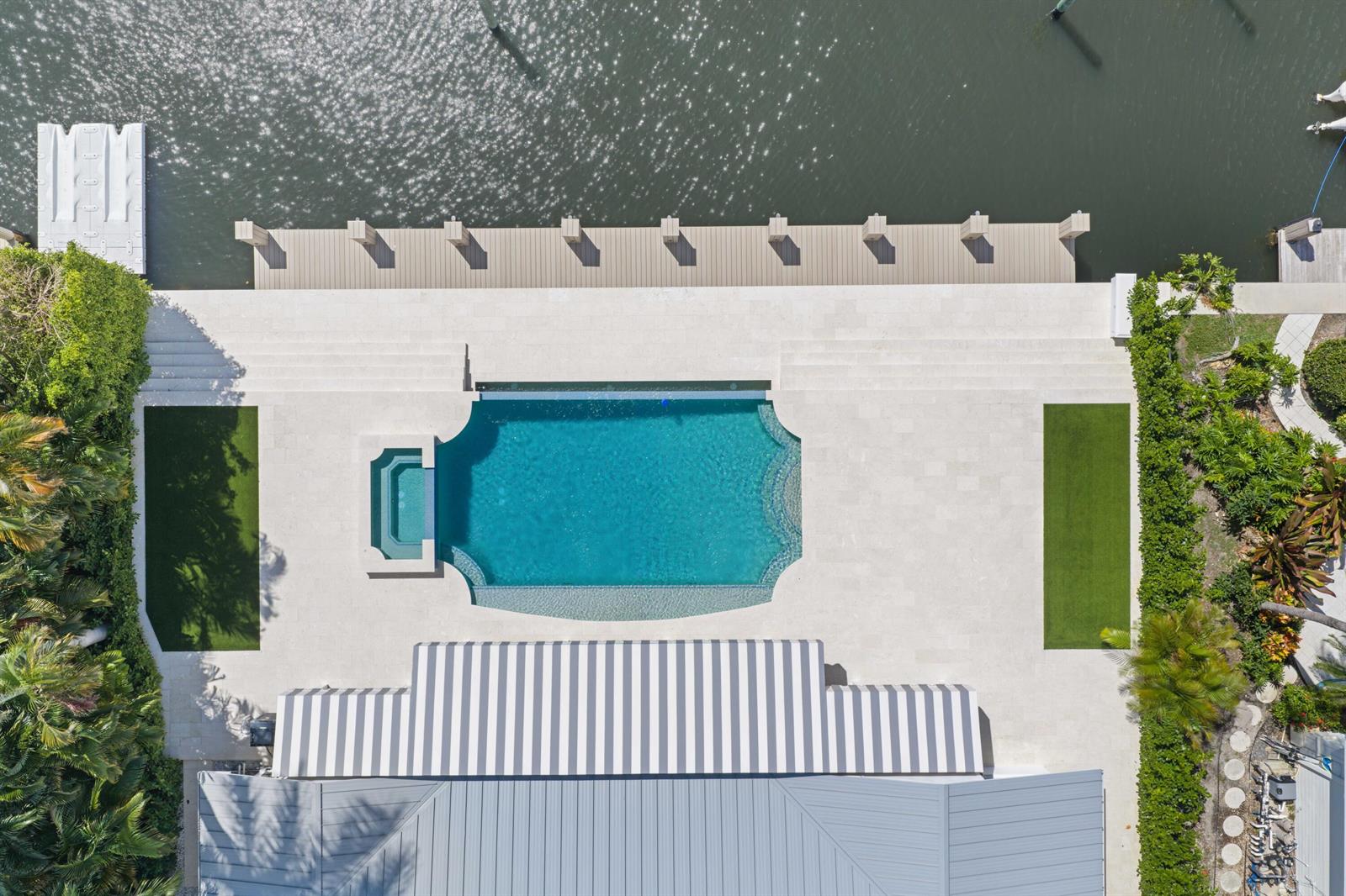 An aerial view shows a waterfront residential neighborhood with a highlighted property featuring a pool — 1102 Island Drive, Delray Beach FL 33483, DELRAY BEACH, FL