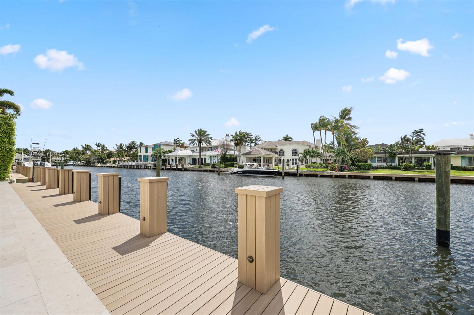 An aerial view of a swimming pool, spa, patio, and dock overlooking a body of water — 1102 Island Drive, Delray Beach FL 33483, DELRAY BEACH, FL