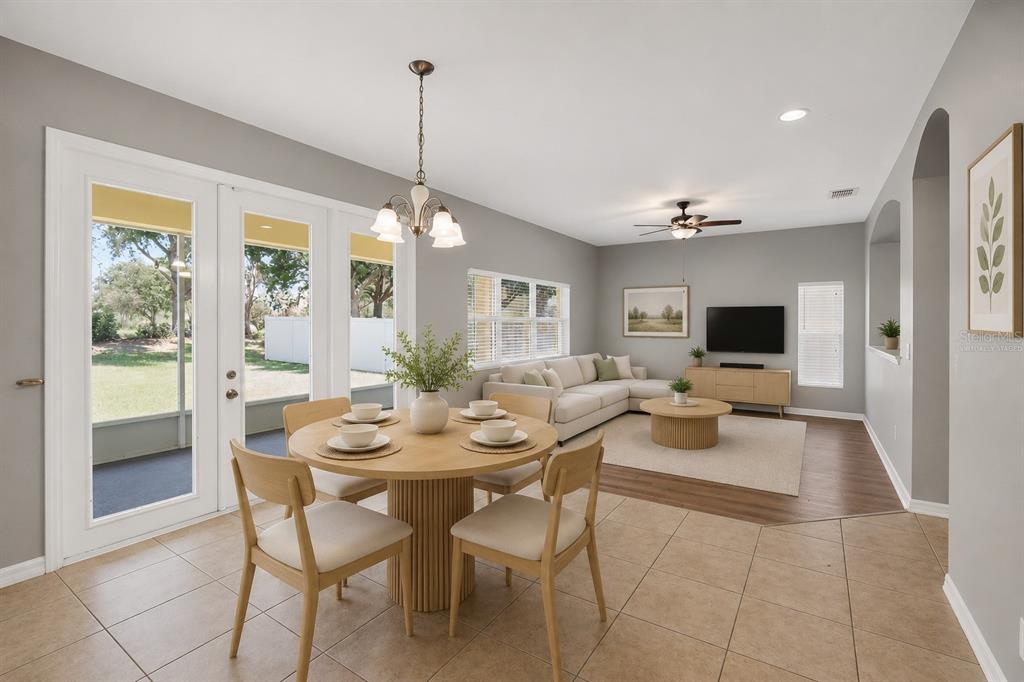 A dining area with a round table opens into a living room with a sectional sofa — 11144 ANCIENT FUTURES DRIVE, TAMPA, FL