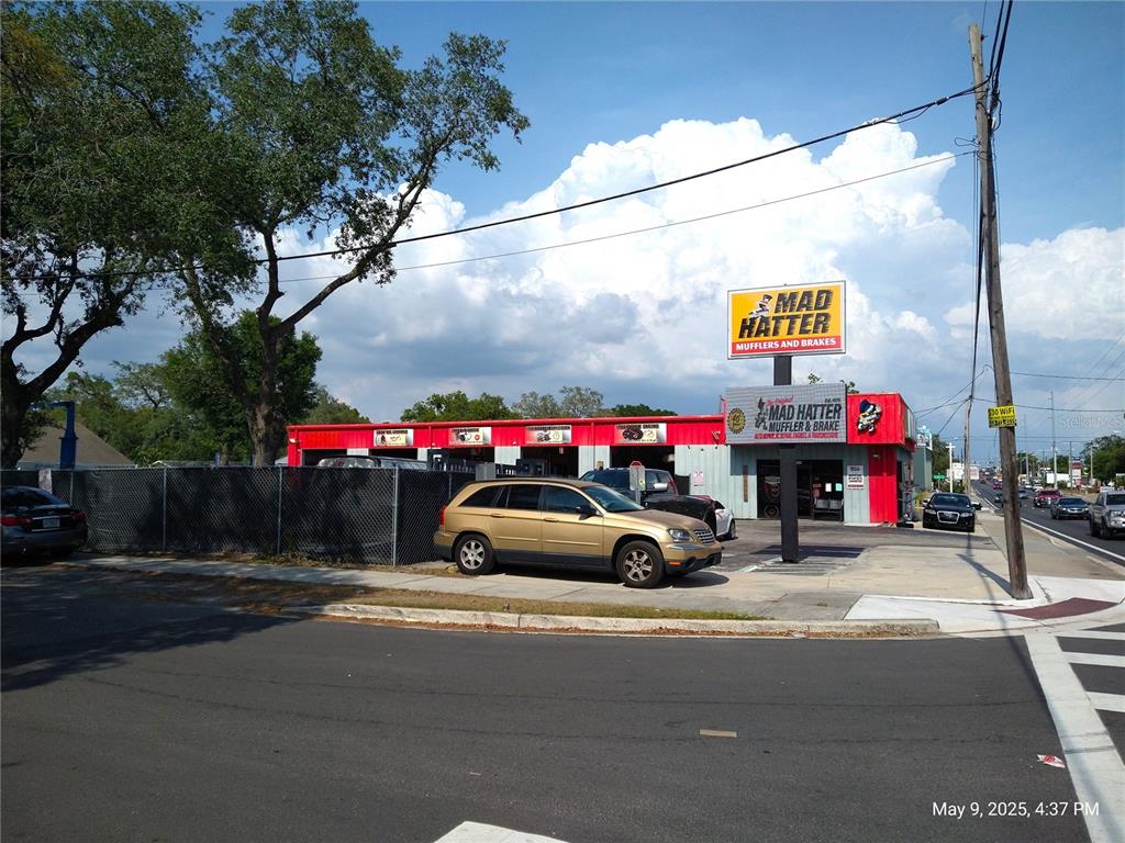 A Mad Hatter Muffler and Brake auto repair shop with a gold SUV parked outside — 715 WEST WATERS AVENUE, TAMPA, FL