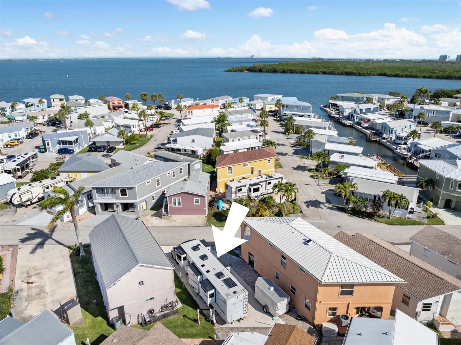 An aerial view shows a recreational vehicle parked between two houses in a coastal community — 340 Nettles Boulevard, Jensen Beach FL 34957, JENSEN BEACH, FL
