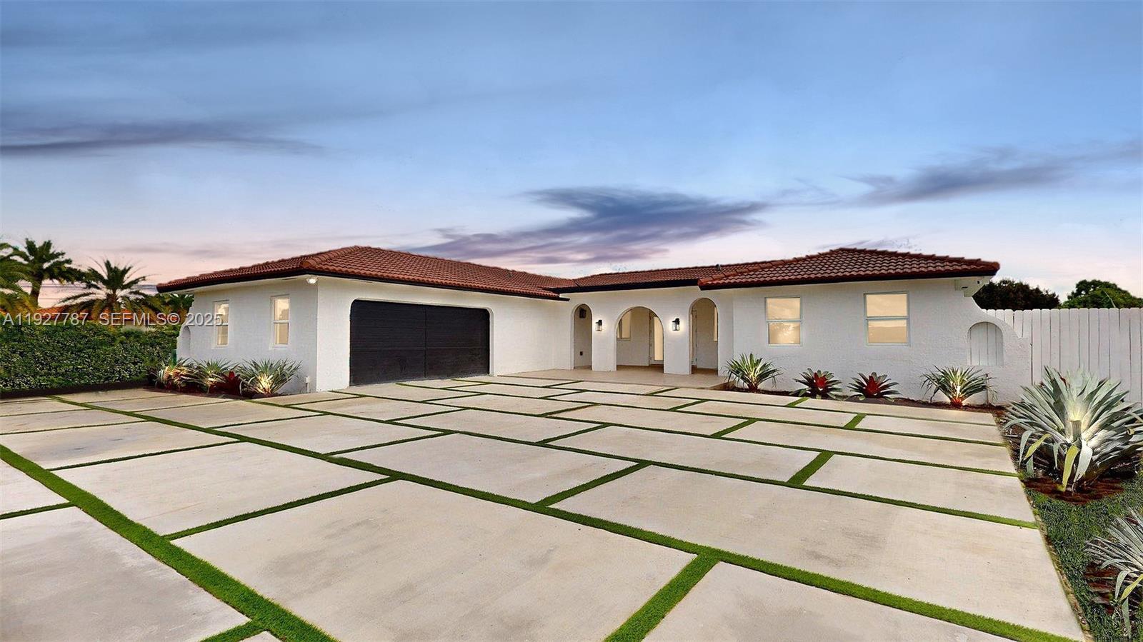 A white single-story house with a tiled roof and a large concrete paver driveway — 3801 SW 132nd Ave, Miami FL 33175, MIAMI, FL