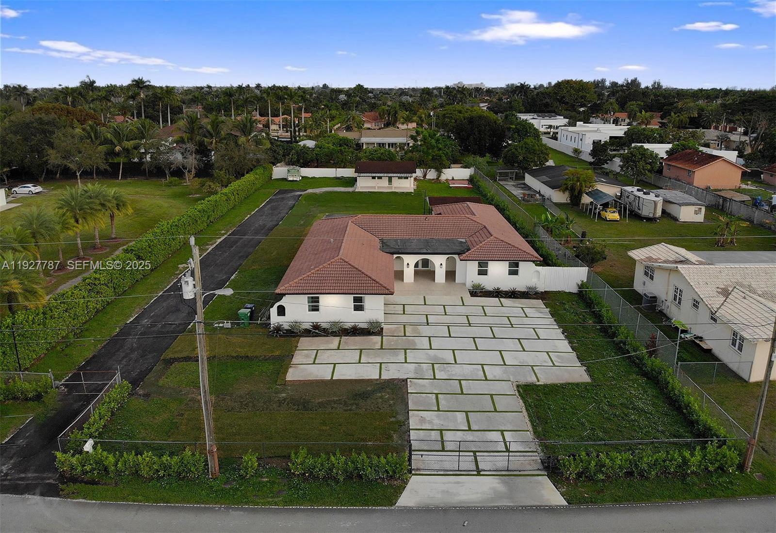 An aerial view shows a white house with a tiled roof and a paved driveway — 3801 SW 132nd Ave, Miami FL 33175, MIAMI, FL