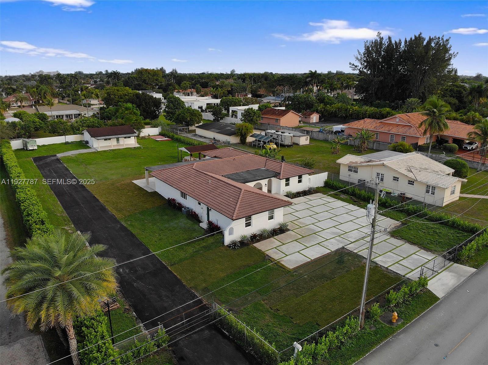 An aerial view shows a white house with a brown tile roof and large driveway — 3801 SW 132nd Ave, Miami FL 33175, MIAMI, FL