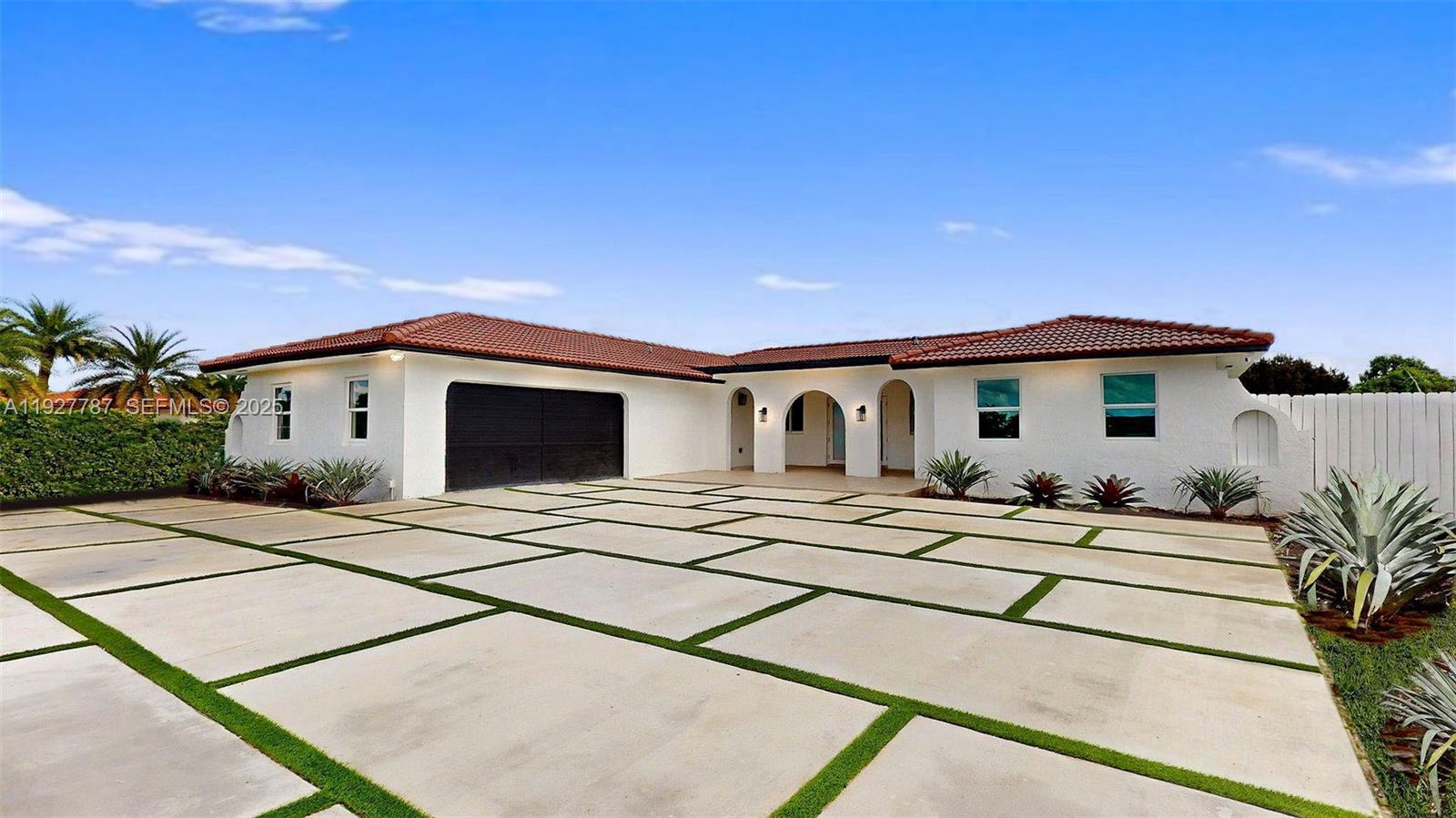 A white single-story house with a tiled roof and a large concrete grid driveway — 3801 SW 132nd Ave, Miami FL 33175, MIAMI, FL