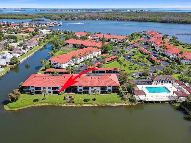A white kitchen features a center island, stainless steel appliances, and light-colored tile flooring — 6081 SE Landing Way # 6, Stuart FL 34997, STUART, FL