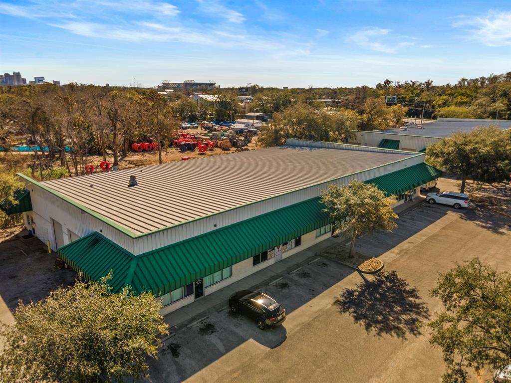 An aerial view shows a commercial building with a green metal roof and parking lot — 3239 OLD WINTER GARDEN ROAD UNIT 12A/12B, ORLANDO, FL