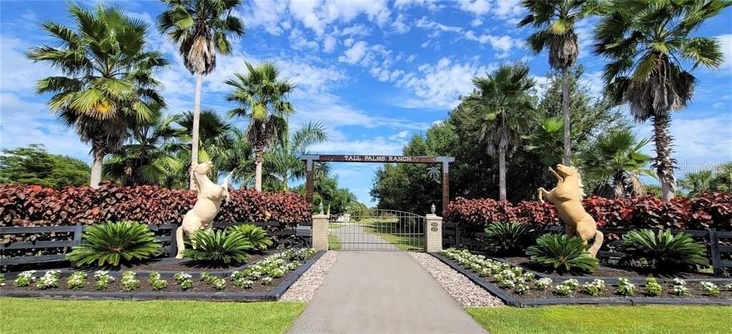 The entrance to Tall Palms Ranch features two horse statues flanking a gated driveway — 3200 ROWLAND DRIVE, PUNTA GORDA, FL
