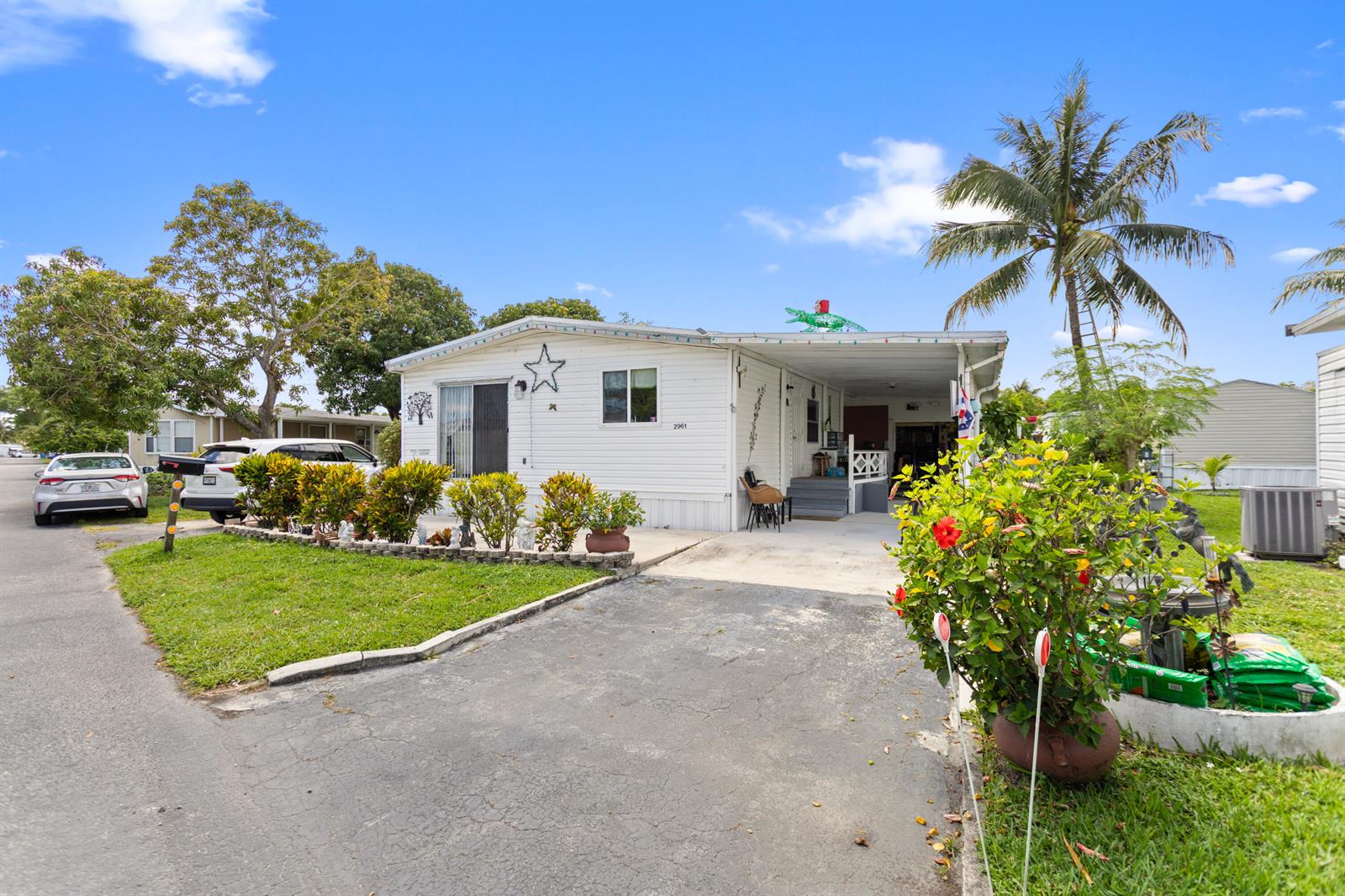 A white mobile home features a carport, a front lawn, and a palm tree — 2961 SW 52nd Terrace, Davie FL 33314, DAVIE, FL