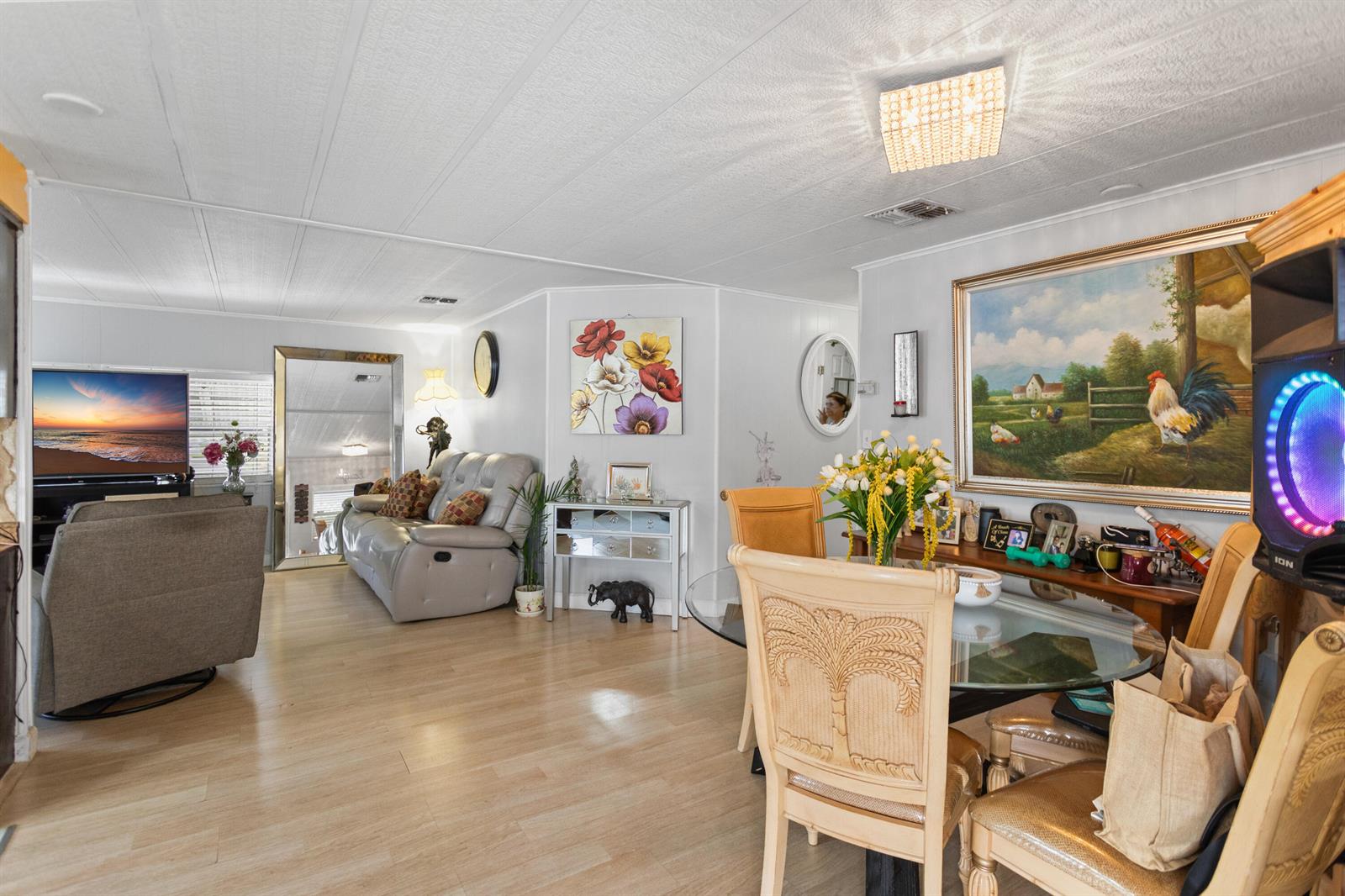 A living and dining area features light wood flooring, a glass table, and wall art — 2961 SW 52nd Terrace, Davie FL 33314, DAVIE, FL