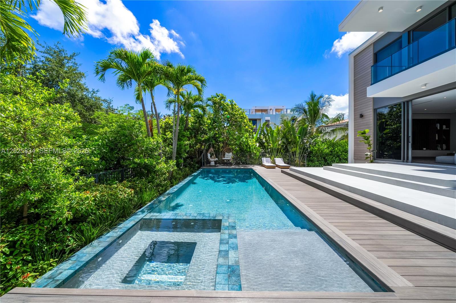 A modern house features a rectangular swimming pool with an integrated spa and wood decking — 571 Glenridge Rd, Key Biscayne FL 33149, KEY BISCAYNE, FL