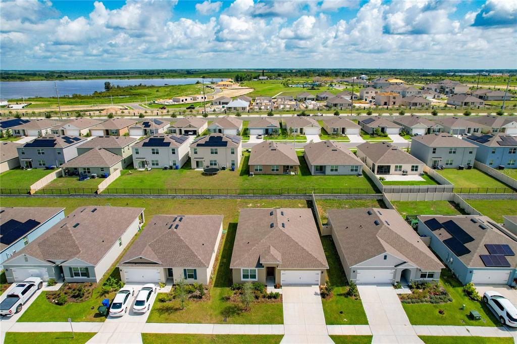 An aerial view shows a suburban neighborhood with rows of single-family homes and driveways — 276 SOFIA LANE, LAKE ALFRED, FL