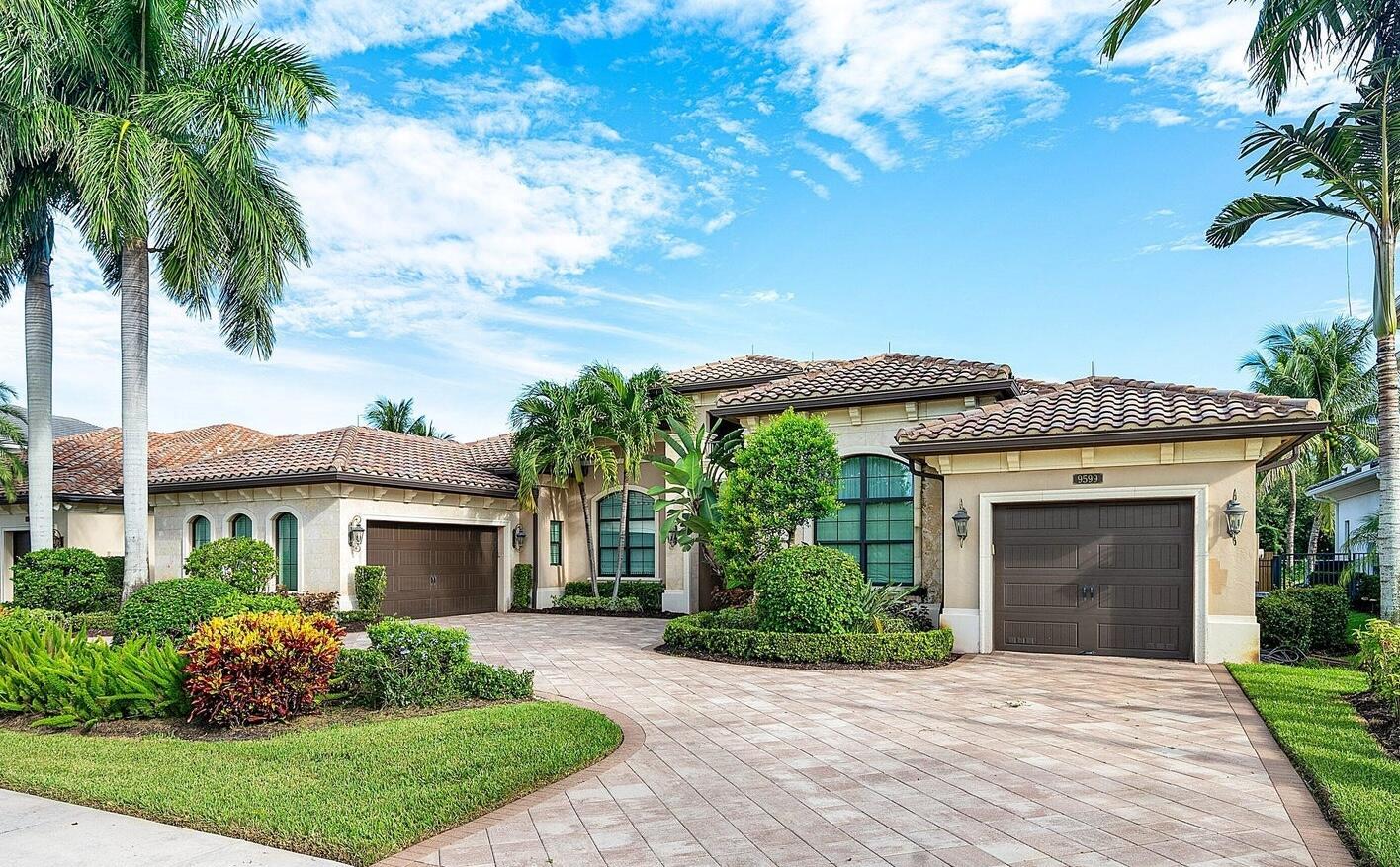 A single-story house with a tiled roof, two garage doors, and a paved driveway — 9599 Moritz Way, Delray Beach FL 33446, DELRAY BEACH, FL