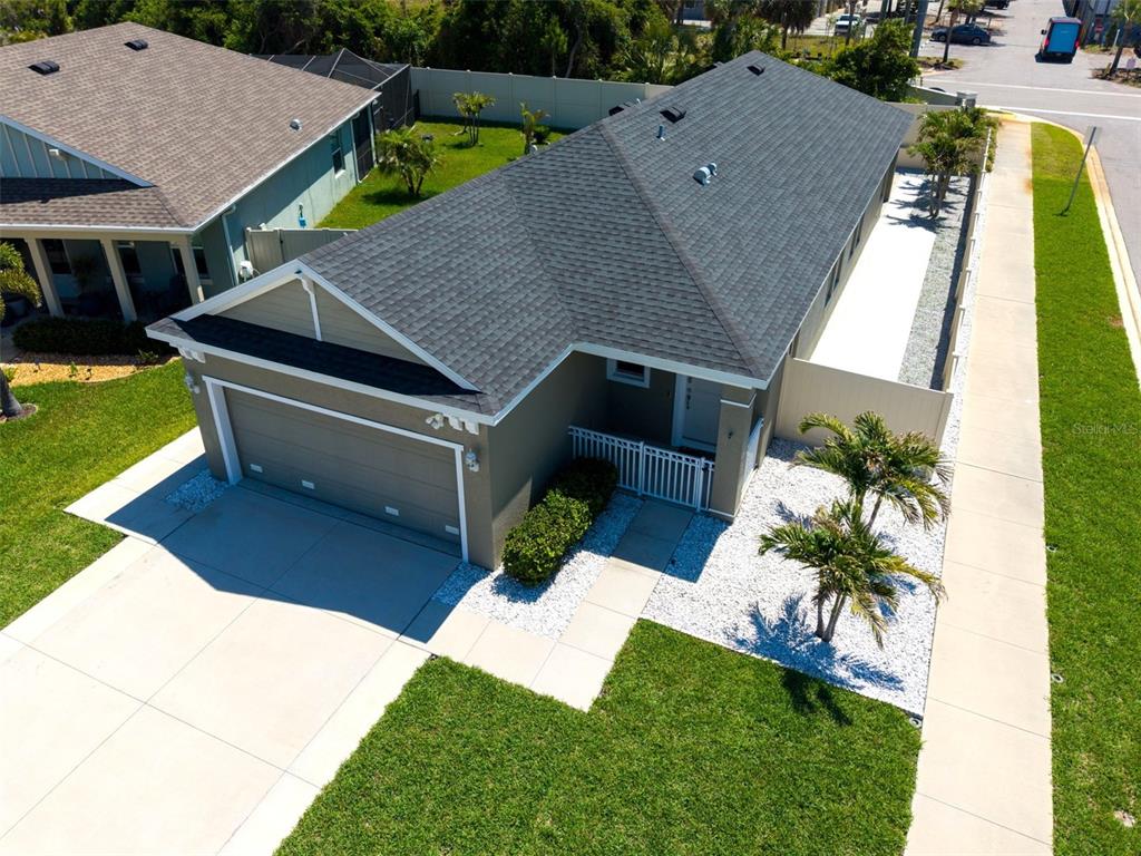 An aerial view of a single-story house with a gray roof, garage, and landscaped yard — 1461 N RIVER CIRCLE, TARPON SPRINGS, FL