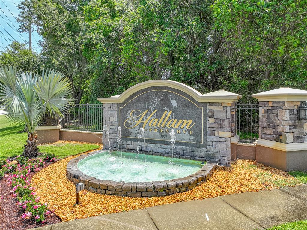A stone monument sign for Hallam Preserve features a small fountain and landscaping — 1547 CORDGRASS WAY, LAKELAND, FL
