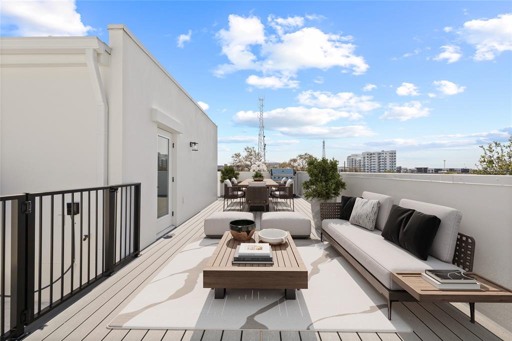 A rooftop deck features a seating area with a sofa, coffee table, and dining set — 301 15TH STREET N, ST PETERSBURG, FL