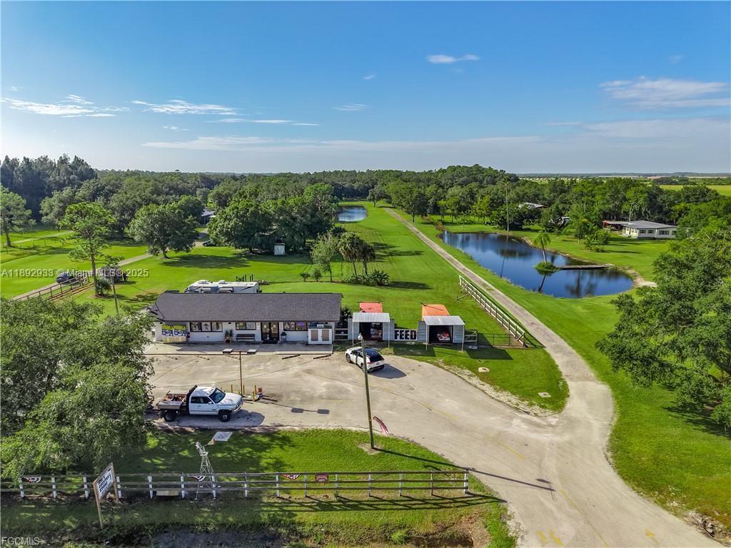 An aerial view shows a commercial building with a feed store sign and two ponds — OTHER CITY - IN THE STATE OF FLORIDA, FL