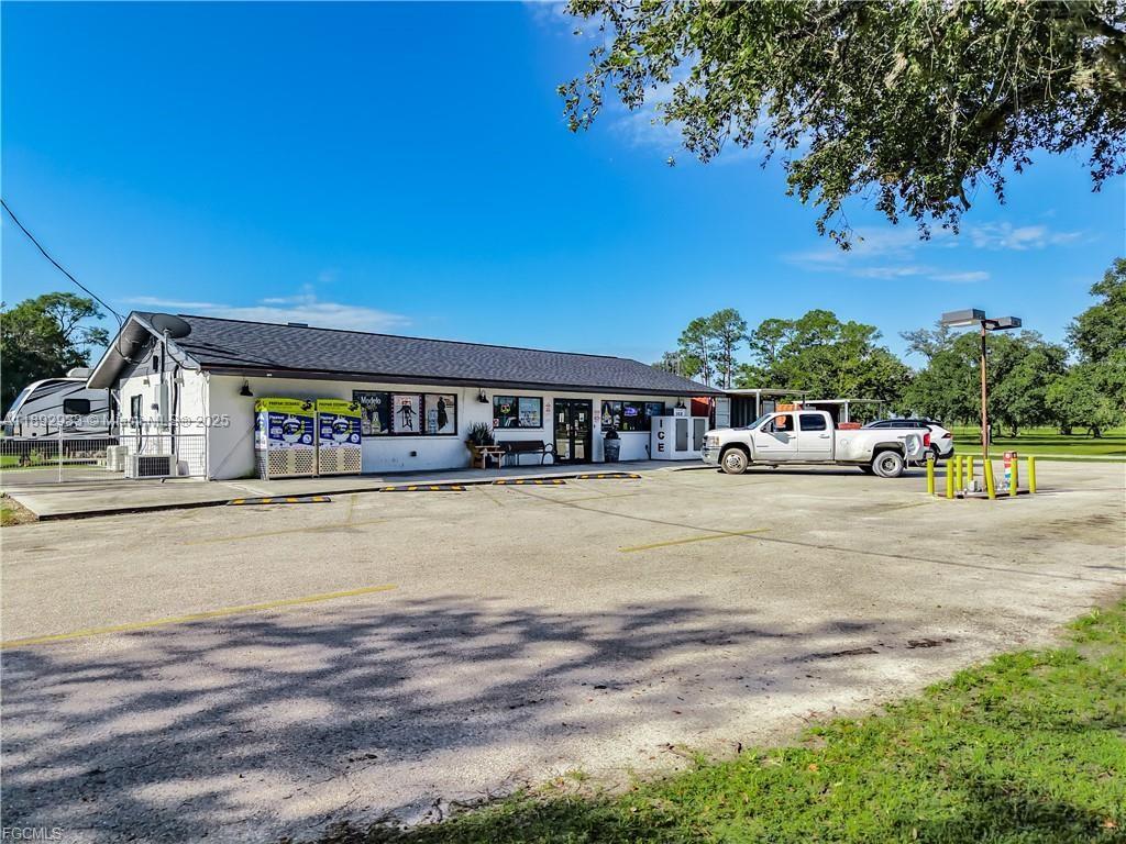 A single-story commercial building with a parking lot and a white pickup truck parked outside — OTHER CITY - IN THE STATE OF FLORIDA, FL