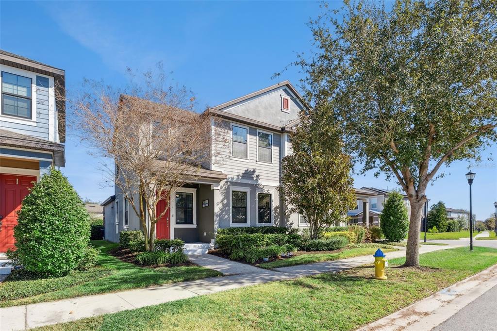 A two-story gray house with a red front door and a small front yard — 5714 COLONY GLEN ROAD, LITHIA, FL