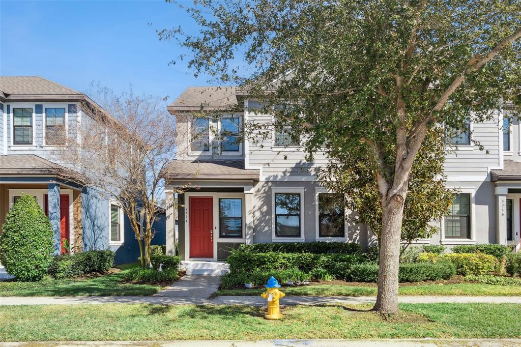 A two-story house with gray siding, a red front door, and a yellow fire hydrant — 5714 COLONY GLEN ROAD, LITHIA, FL