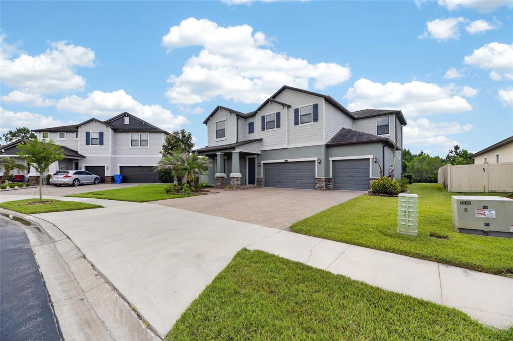 A two-story suburban house with a three-car garage and a paved driveway — 2905 HILLIARD DRIVE, WESLEY CHAPEL, FL