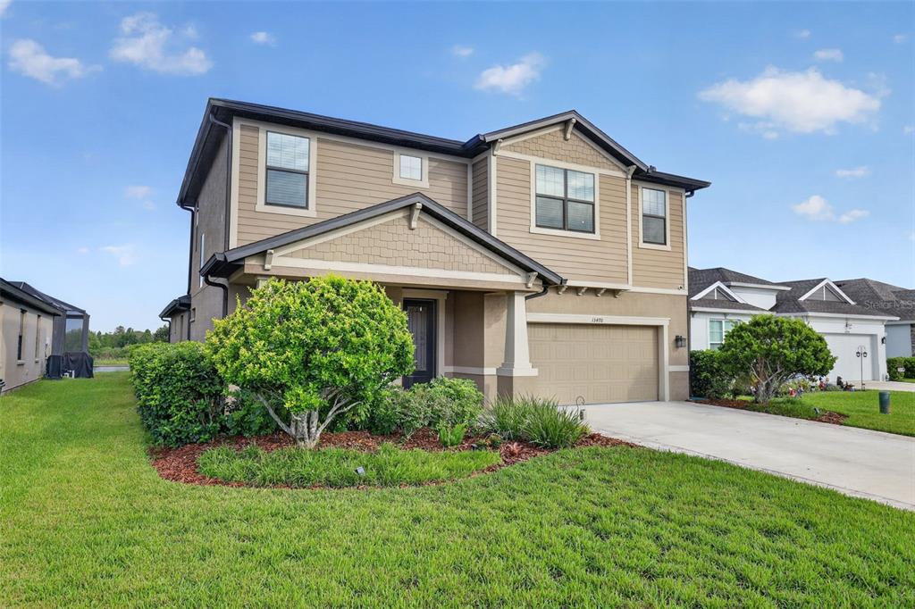 A stone fire pit with a burning fire sits on a patio with four chairs — 13470 NEWPORT SHORES DRIVE, HUDSON, FL