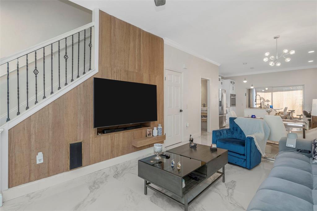 A living room features a gray sofa, a blue armchair, a coffee table, and tile flooring — 6765 LAKE ROCHESTER LANE, GIBSONTON, FL