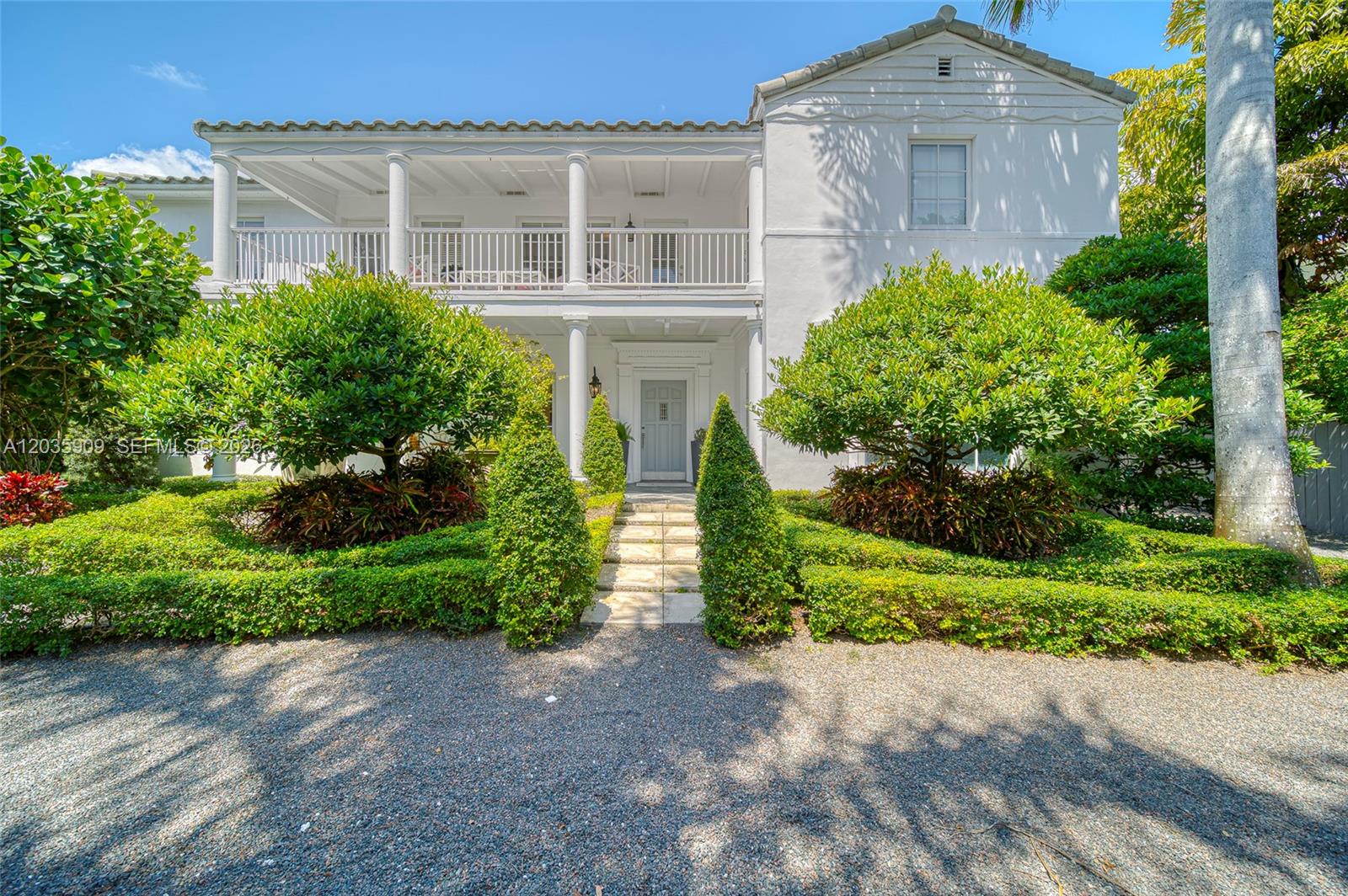 A two-story white house with a columned balcony and a gravel driveway — 2534 Flamingo Dr, Miami Beach FL 33140, MIAMI BEACH, FL