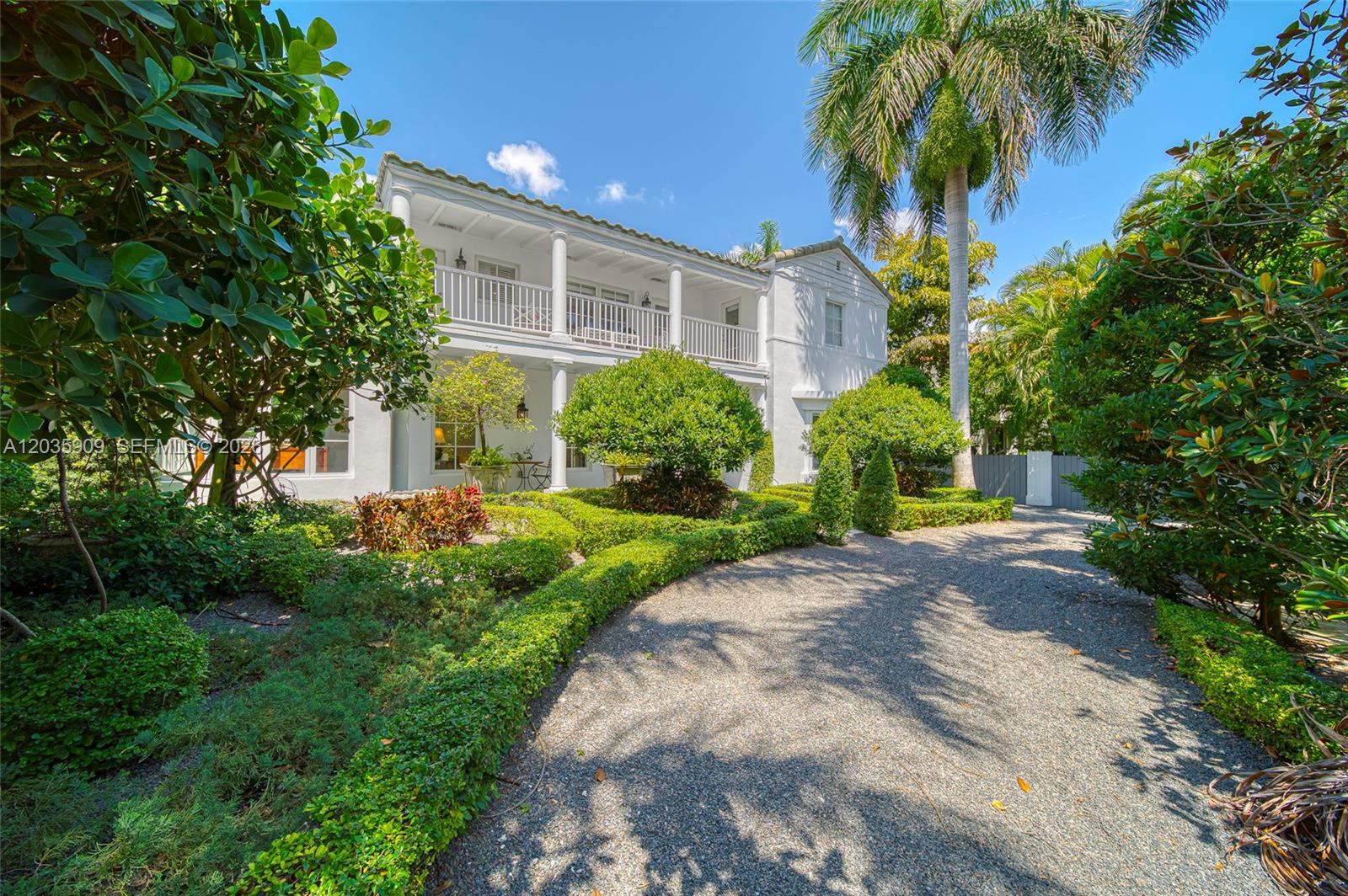 A two-story white house with a balcony and columns sits behind a gravel driveway — 2534 Flamingo Dr, Miami Beach FL 33140, MIAMI BEACH, FL