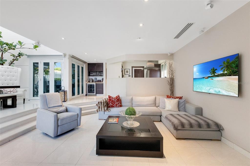 A modern living room features a sectional sofa, a coffee table, and a wall-mounted television — 2008 ESPAÑA STREET, SAN JUAN, PR