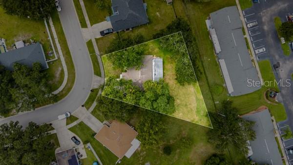 An aerial view shows a residential property lot outlined in green within a suburban neighborhood — 2472 PINE CHASE CIRCLE, ST CLOUD, FL