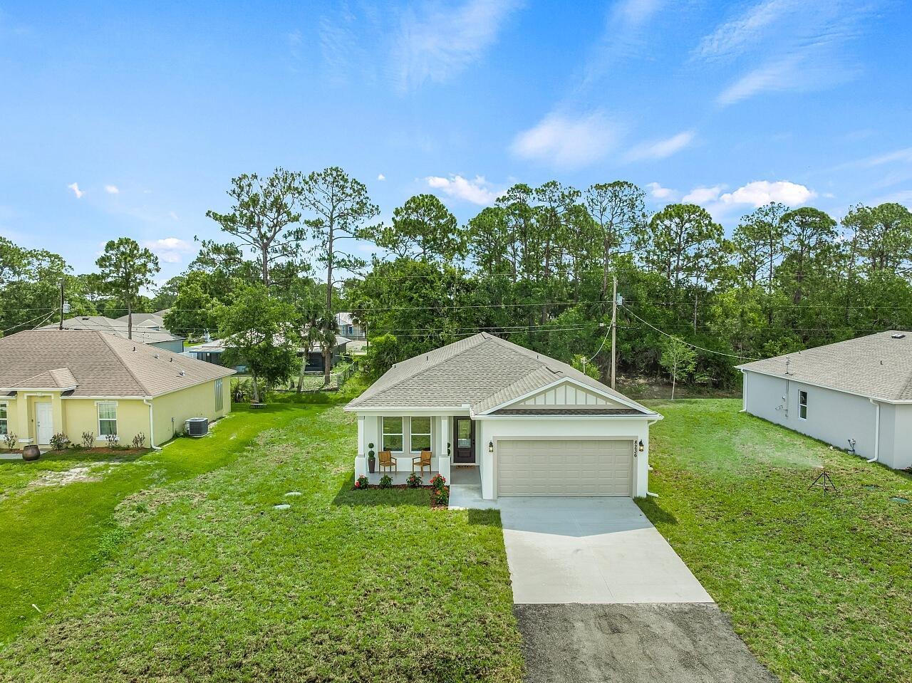 An aerial view of a single-story house with a two-car garage and front porch — 8236 104th Court, Vero Beach FL 32967, VERO BEACH, FL