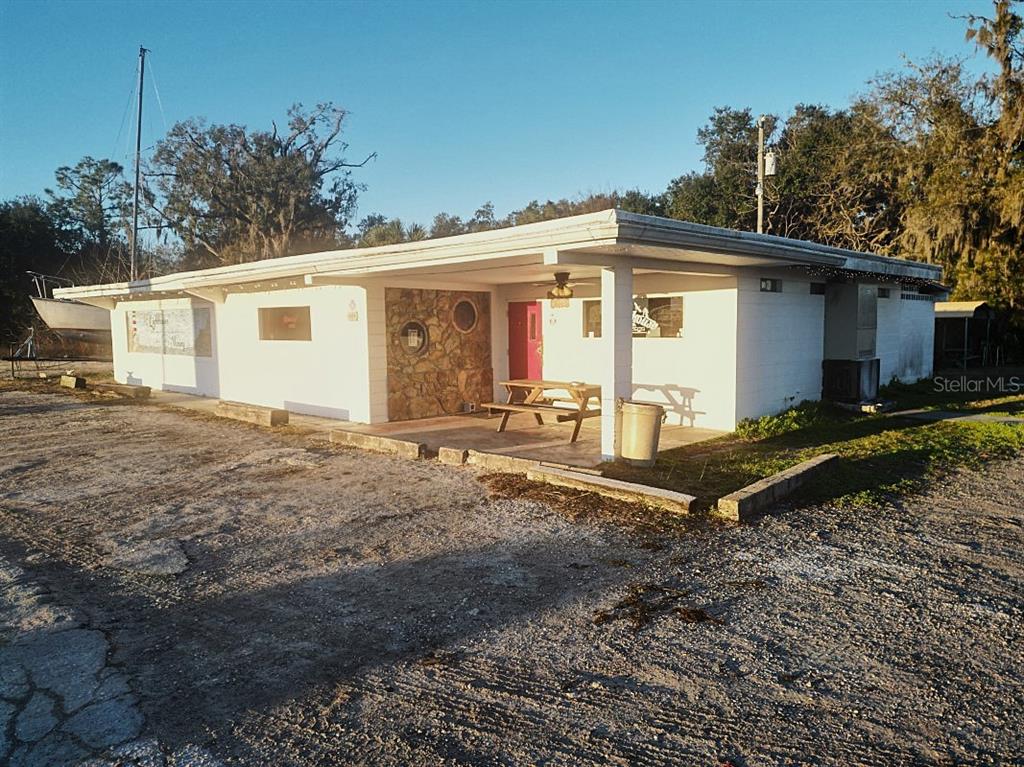 A single-story white building with a stone accent wall and a covered front porch area — 5025 TREIMAN BOULEVARD, DADE CITY, FL