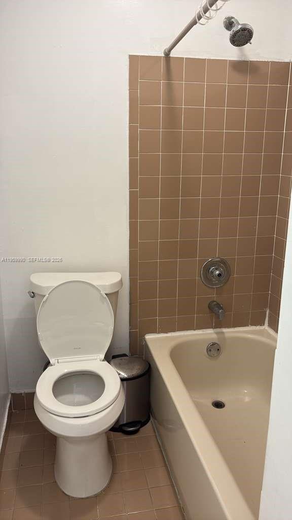 A bathroom features a beige bathtub with brown wall tiles, a toilet, and a showerhead — 6911 SW 129 AV # 5, Miami FL 33183, MIAMI, FL