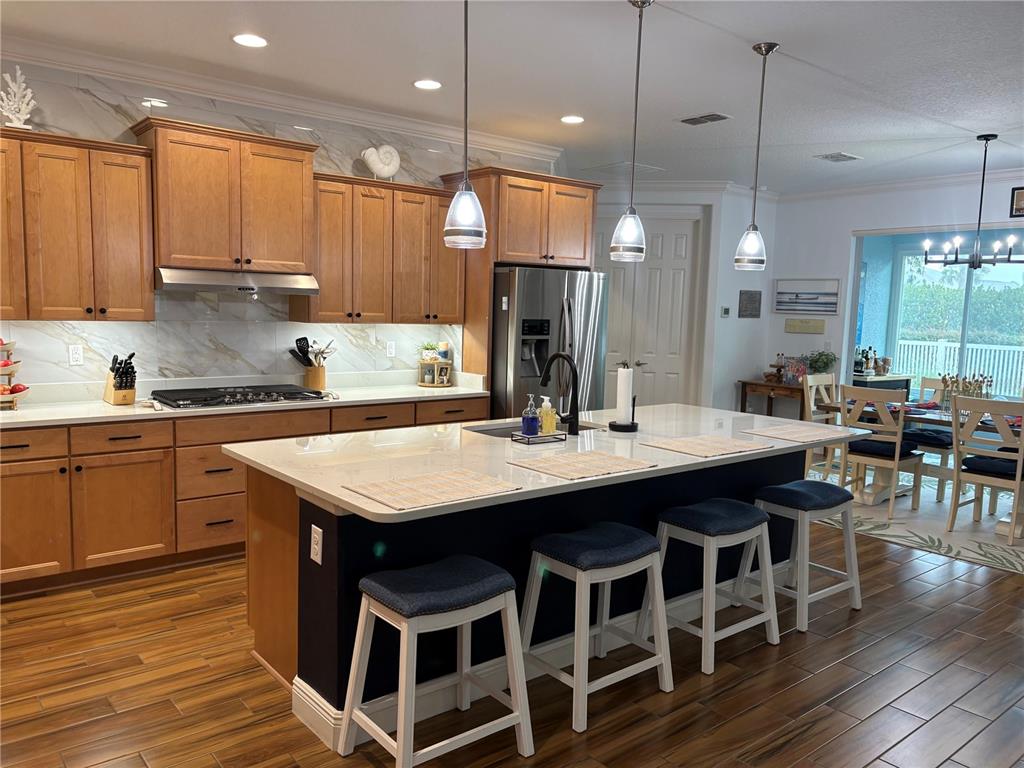 A single-story house with a paved driveway, a covered front porch, and landscaped garden beds — 8649 SW 94TH CIRCLE, OCALA, FL