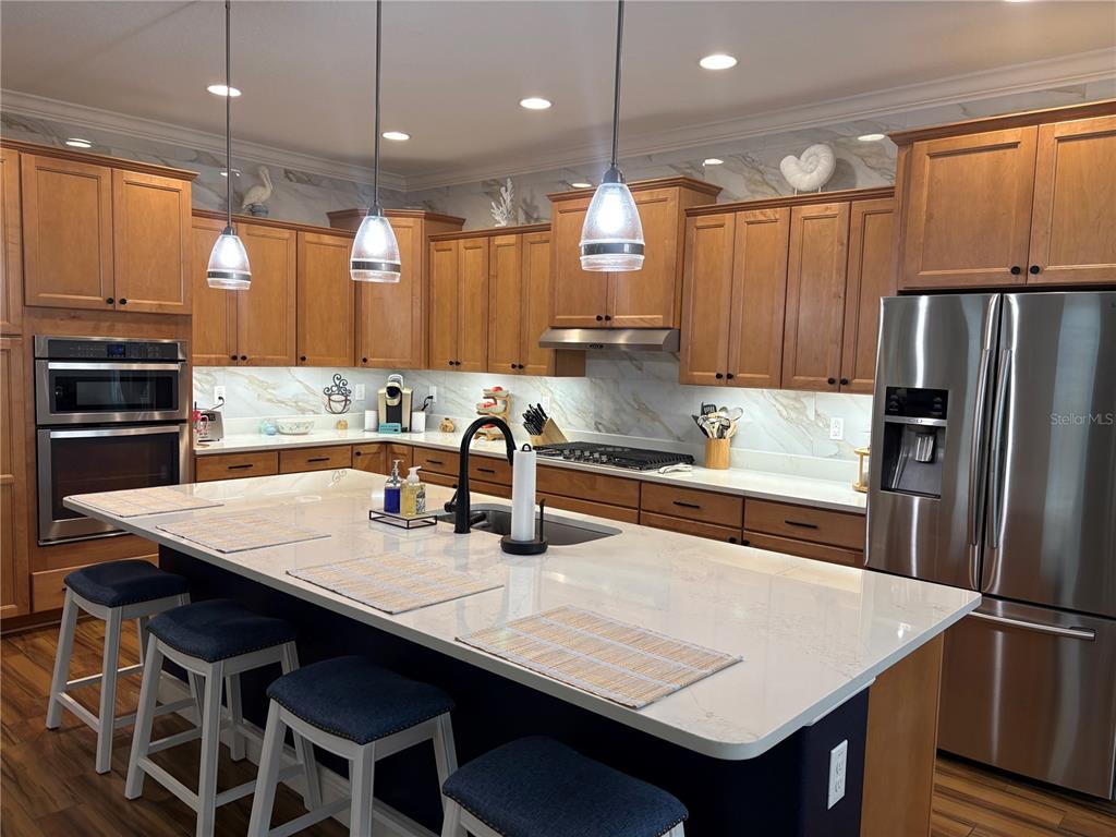 A single-story house with a tan exterior, a covered porch, and a landscaped front yard — 8649 SW 94TH CIRCLE, OCALA, FL