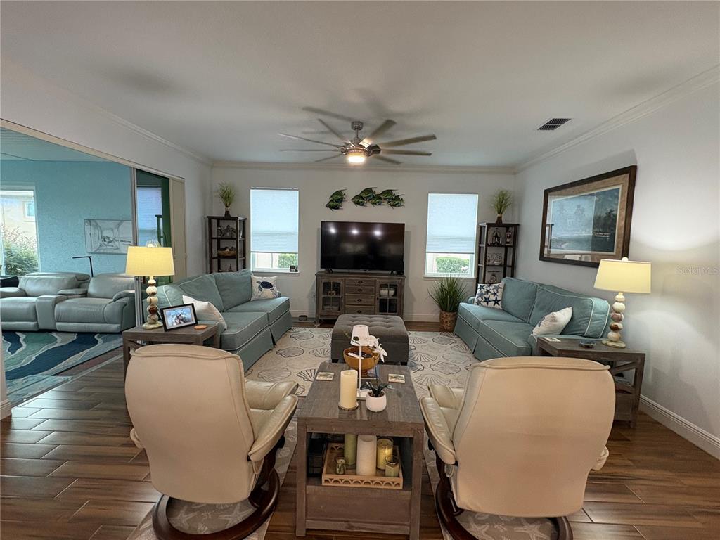 A single-story house with a beige exterior, a covered porch, and a two-car garage — 8649 SW 94TH CIRCLE, OCALA, FL