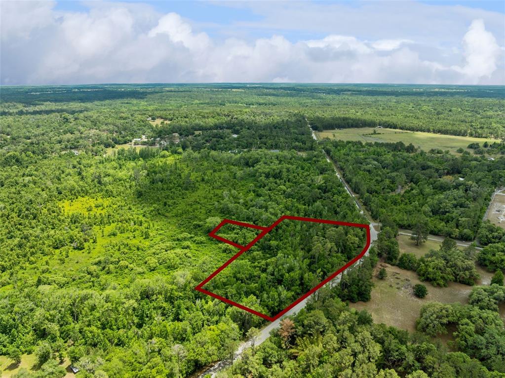 An aerial view shows a wooded plot of land outlined in red along a road — CULBREATH ROAD, BROOKSVILLE, FL